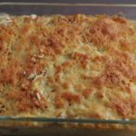 Chicken tetrazzini recipe made with spaghetti, parmesan cheese, and a creamy homemade sauce served in a clear casserole dish baked with cheese on top.