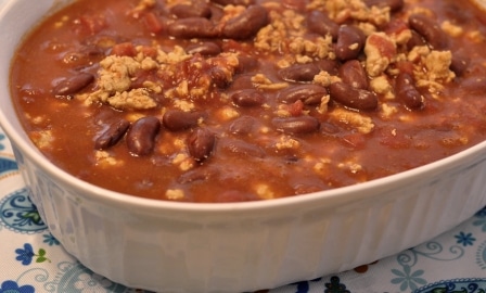 Chili in a white casserole dish on a blue and white placemate