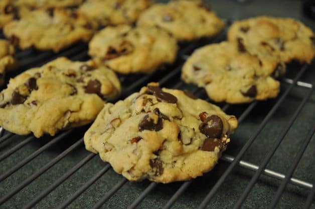 Baked chocolate chip cookies cooling on a wire rack.