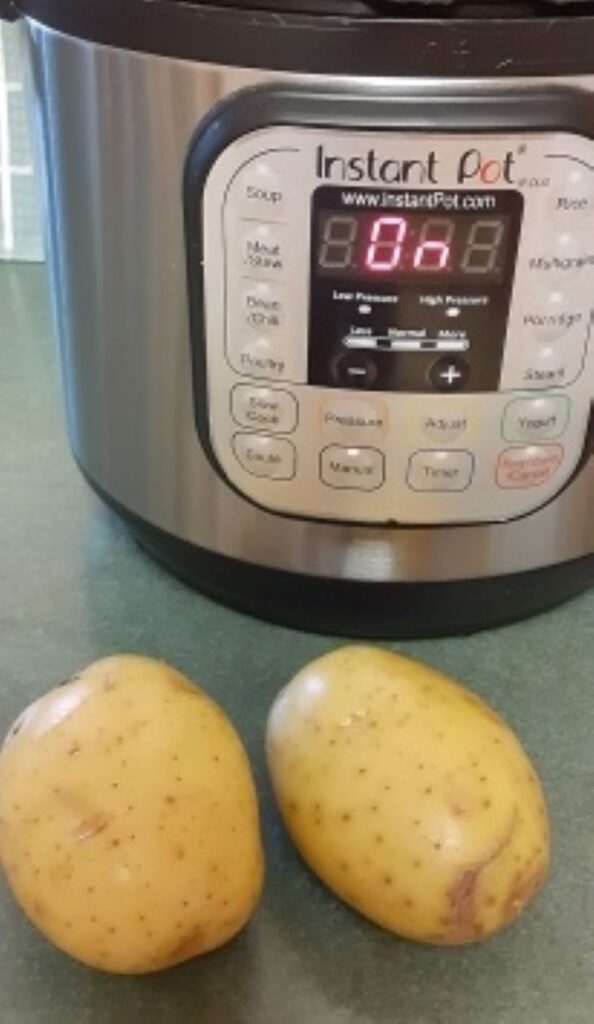 Two potatoes ready to bake in the Instant Pot behind them.
