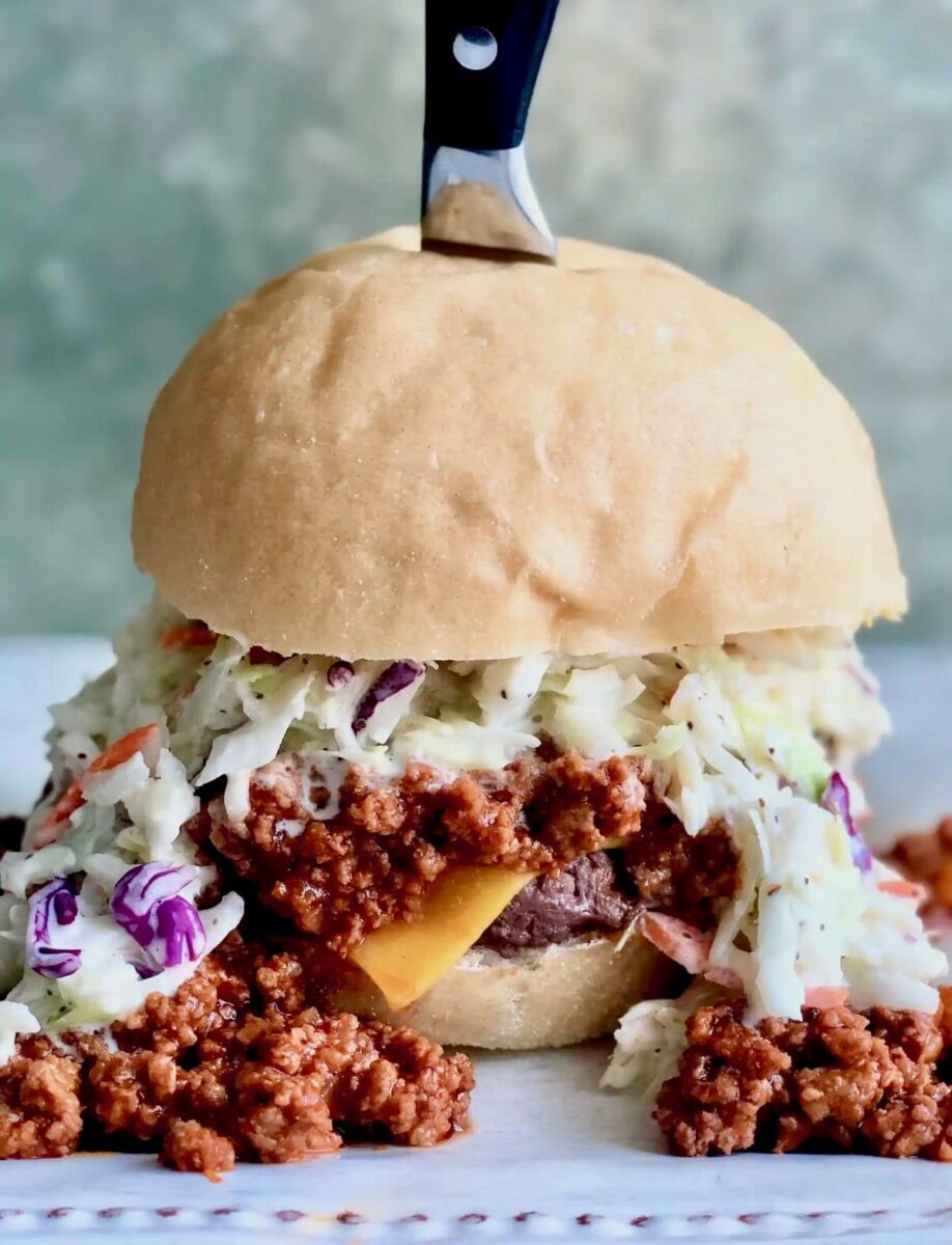 Carolina burger with coleslaw on a serving plate.