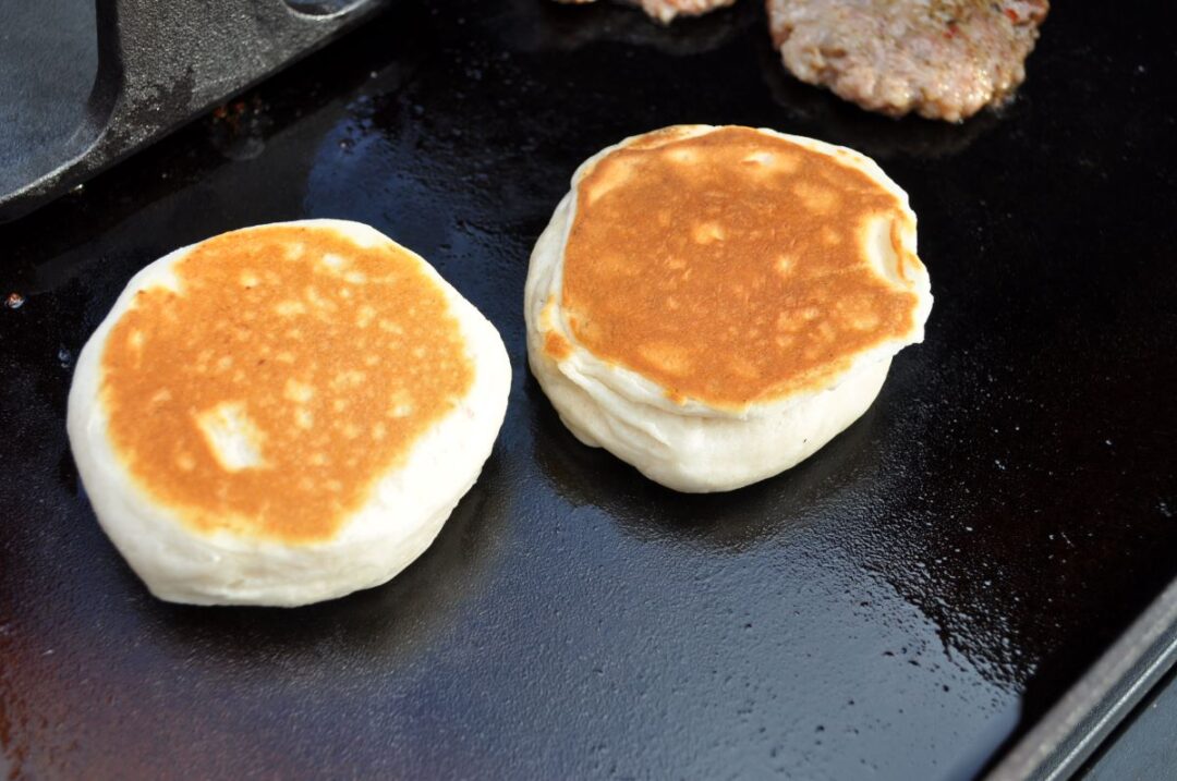 Biscuits cooking on a Blackstone griddle.