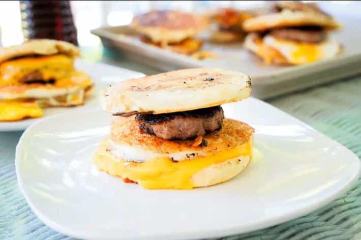 Blackstone McGriddle with sausage, cheese and English muffin on a plate.