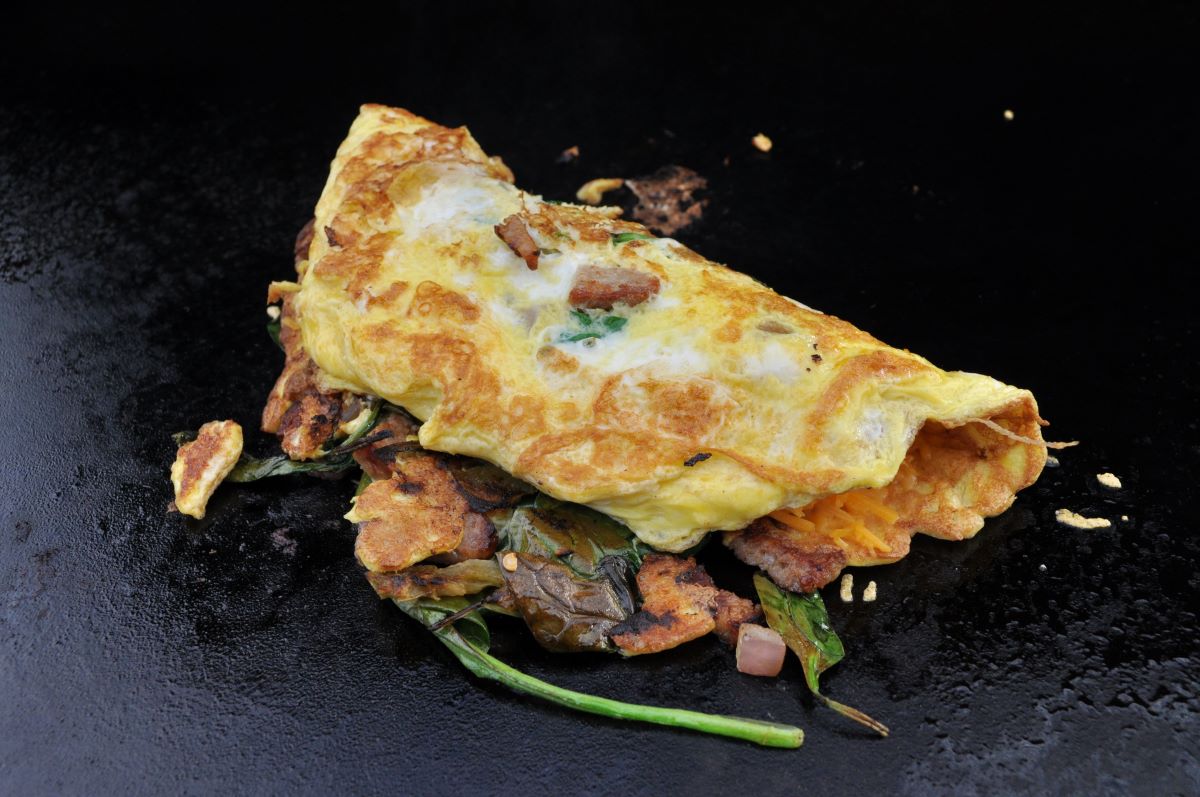 Blackstone Omelette with cheese, eggs, spinach, mushrooms, tomatoes, ham and onions. Ready To Serve.