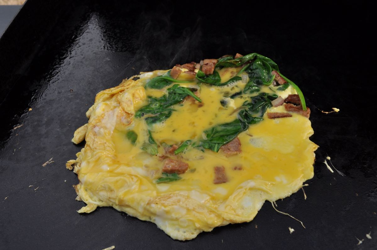 Blackstone Omelette eggs cooking on a griddle.