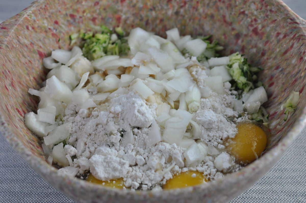 Zucchini souffle casserole ingredients in a bowl.