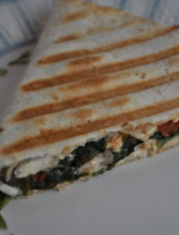 Quesadilla with chicken, spinach, cheese cooked with golden brown stripes on a Cuisinart griddle.
