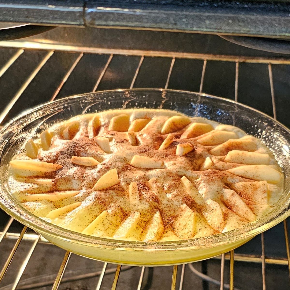 German pancakes  baking in oven in a round glass pie dish at 375 degrees Fahrenheit for 18 to 20 minutes.  Alternate dishes to bake in include a cast iron skillet or other oven safe baking dish.